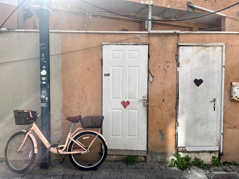 Pink bike leaning on a wall 